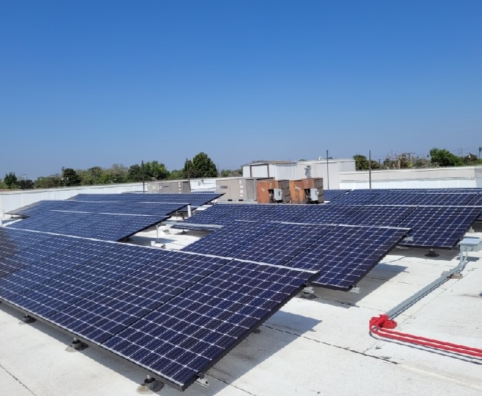 Rows of large commercial solar panels tilted toward the sun in Cerritos.