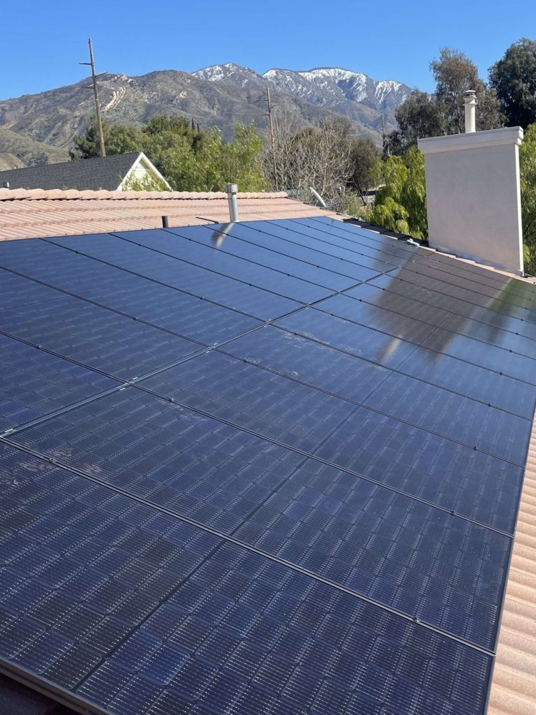 A large block of solar panels on the roof of a home.