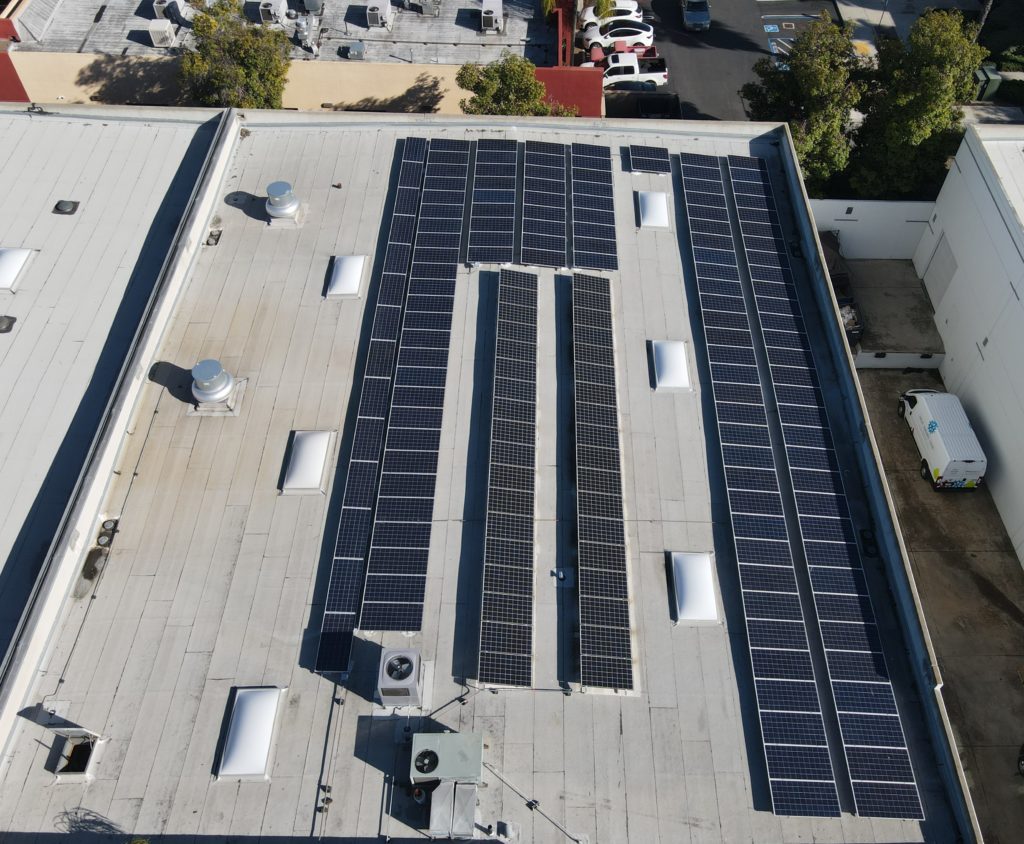 Aerial shot of several rows of solar panels on a manufacturing center in Poway