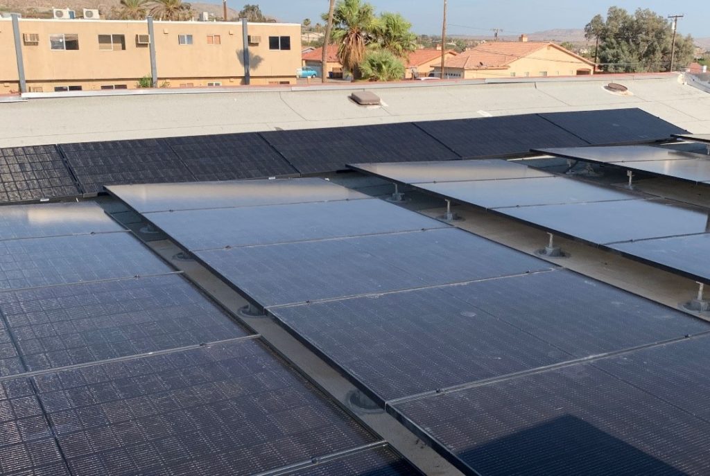 View from atop the roof of a commercial office building of new solar panels. 