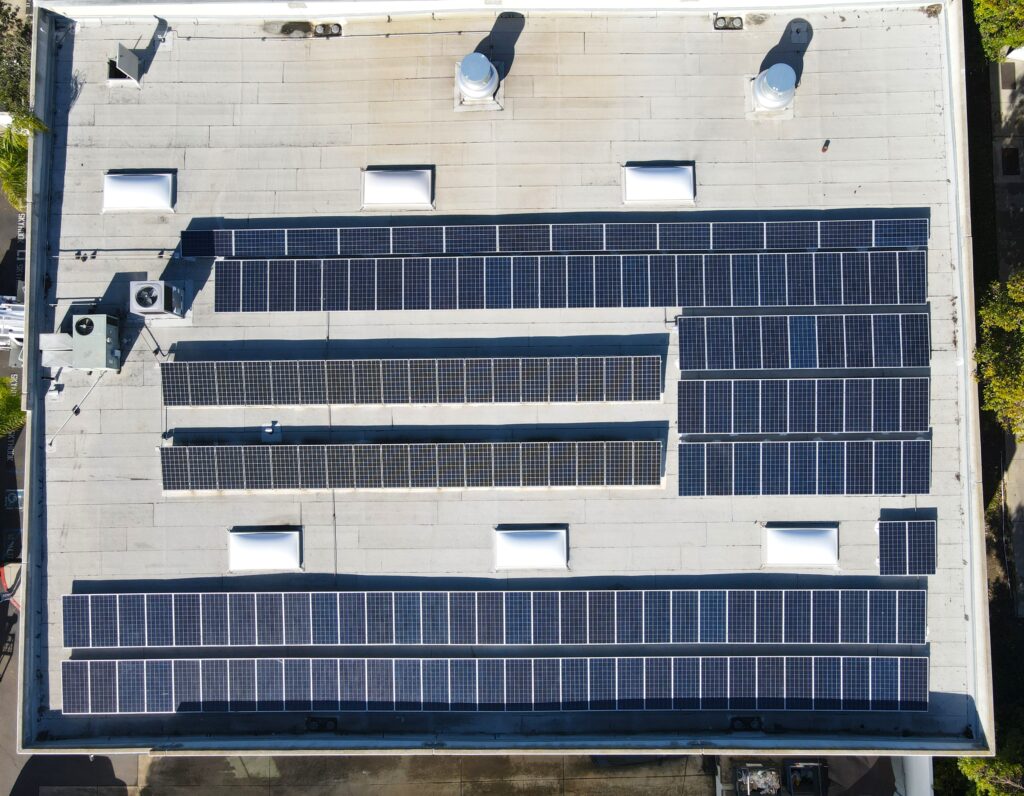 Commercial solar panel installation on roof of a manufacturing center.