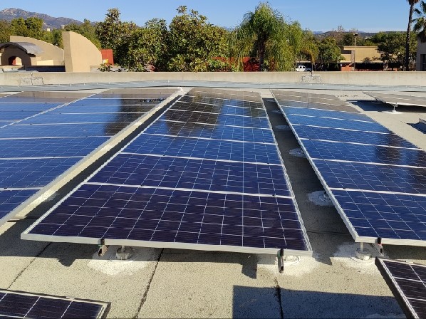 Commercial solar panel installation on the roof of a manufacturing center.